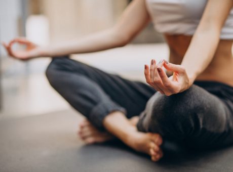 Young woman practicing yoga at home